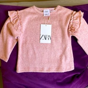 Beautiful, soft light pink sweater with ruffle details. Brand new with tags.